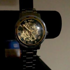 Gold and silver watch mechanical movement inside